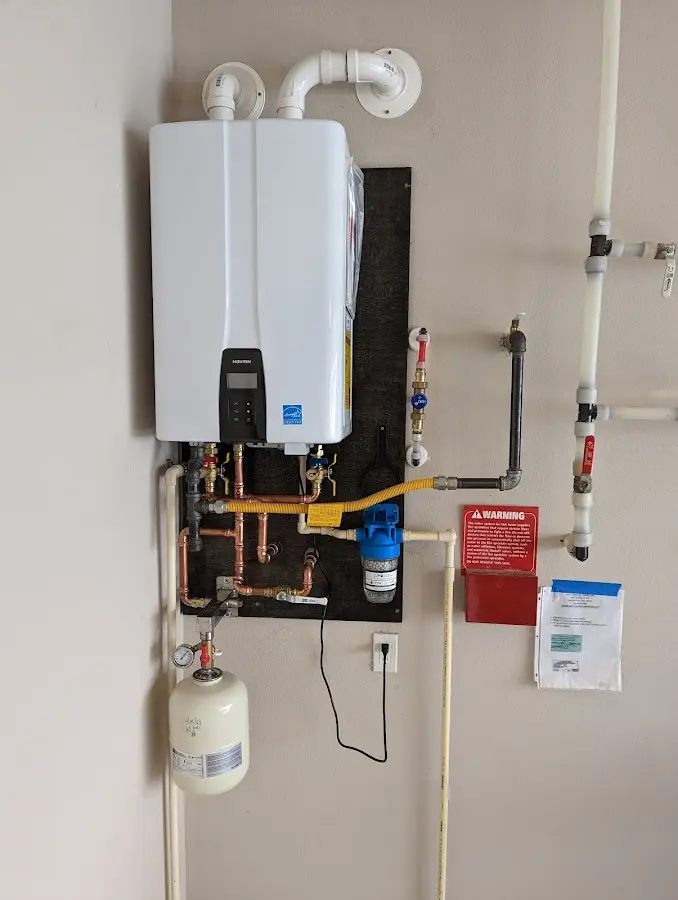 Professional plumber installing copper piping in a Bar Harbor home